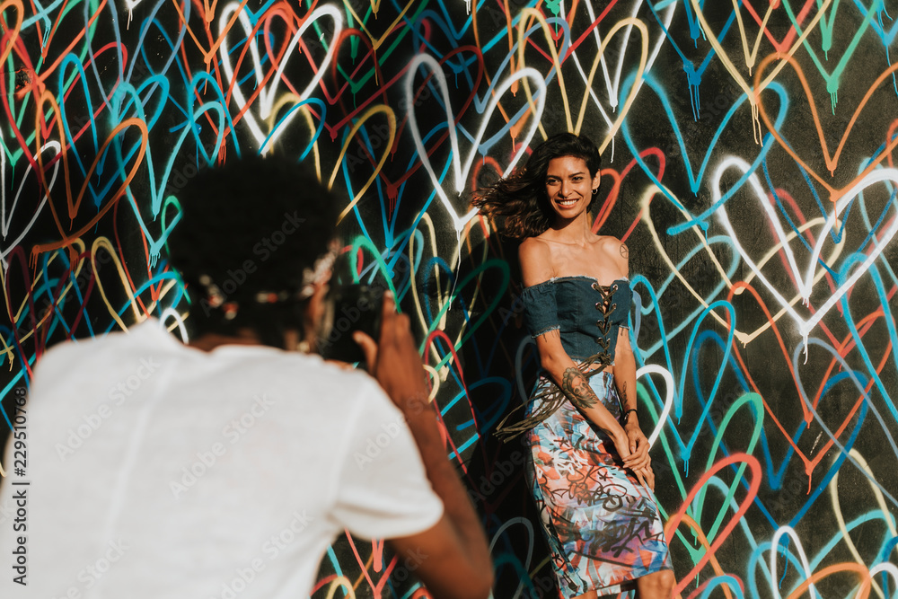 Beautiful model posing by a wall