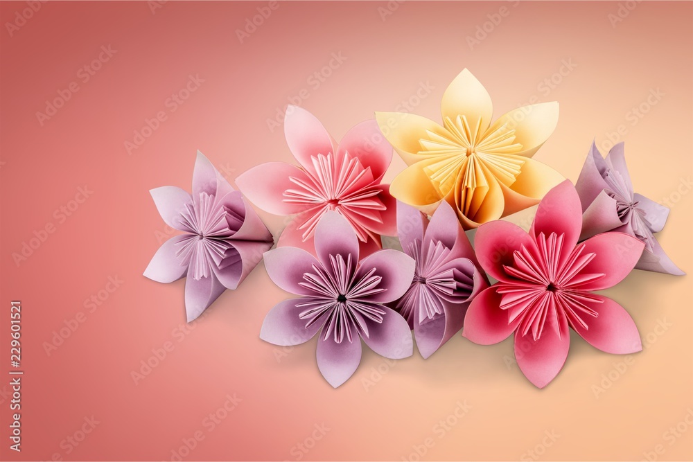 Origami flowers on white background