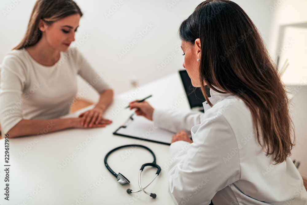 Close-up image of doctor consulting patient.