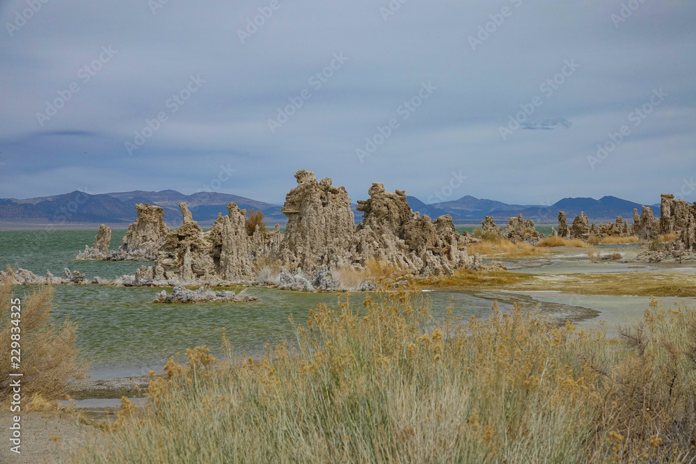 Fascinating rocky towers sticking out of the tranquil lake beneath the mountains