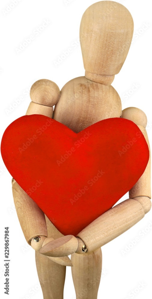 Miniature wooden mannequin holding a heart