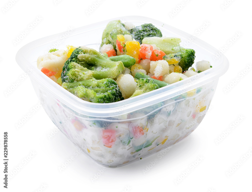 Plastic container with frozen vegetables on white background