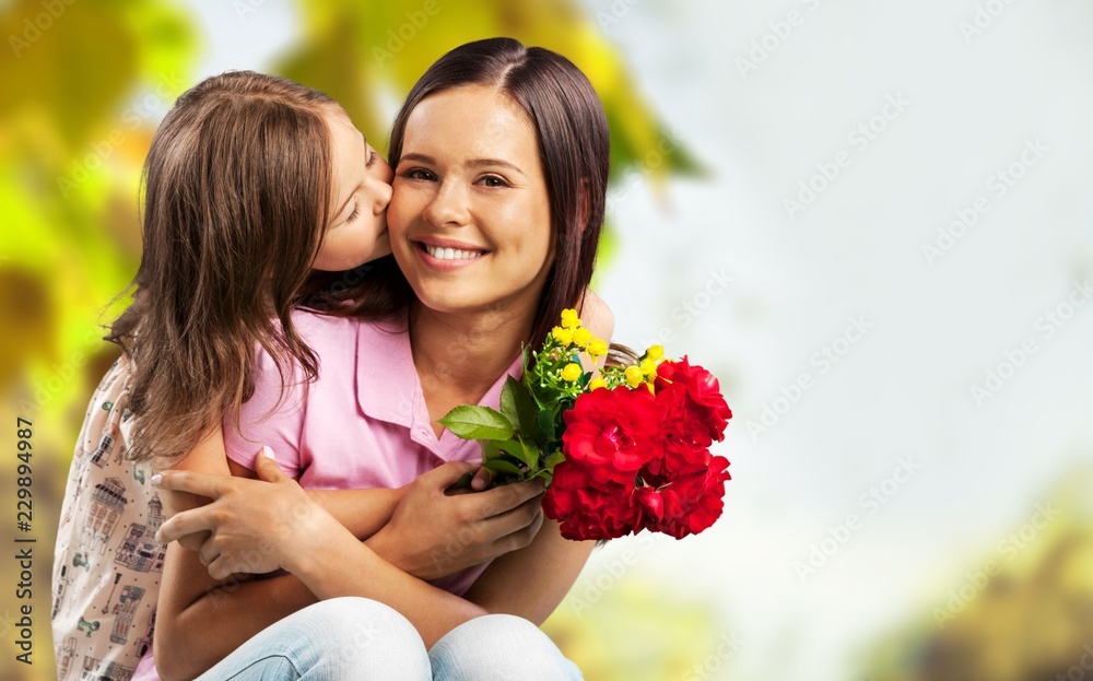 Happy Mother and daughter hugging  with flowers