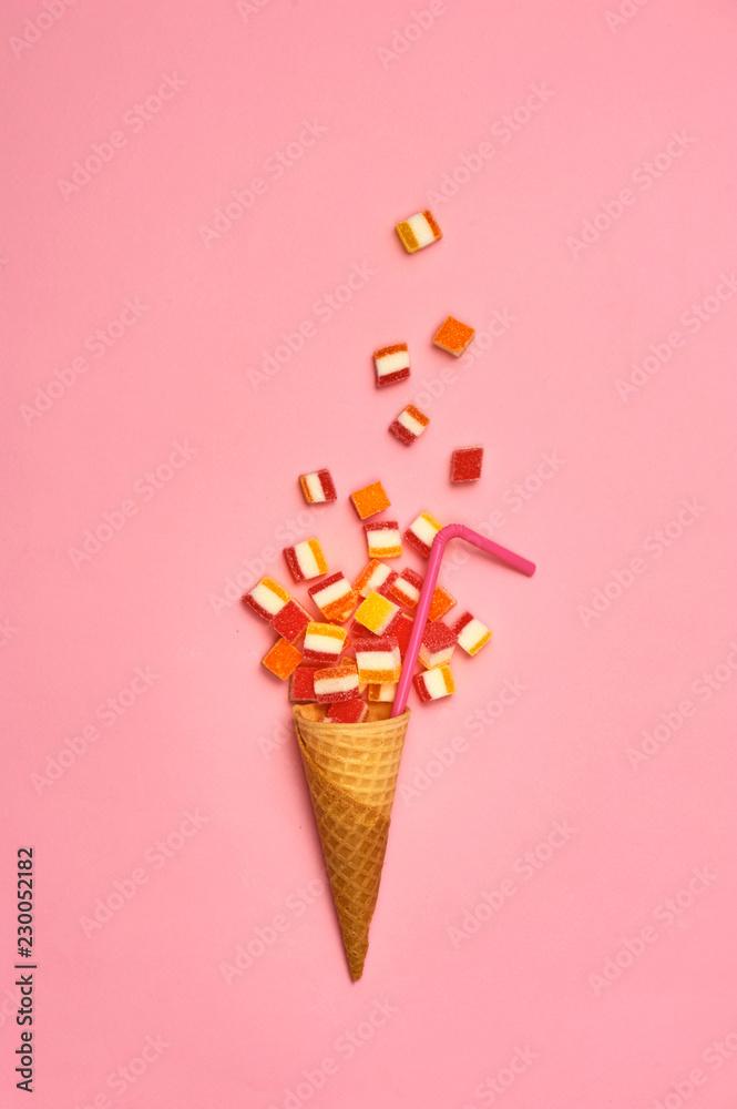 Flat lay : Ice cream cone with colorful party streamers on yellow background with copy space