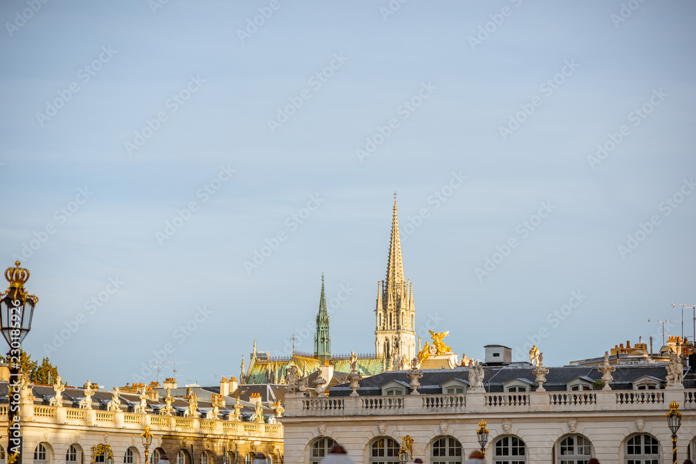 Cityscape view on the central square with beautiful buildings and cathedral tower in Nancy, France