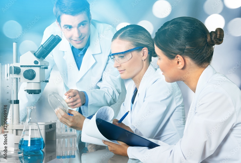 Female and male scientists in glasses working