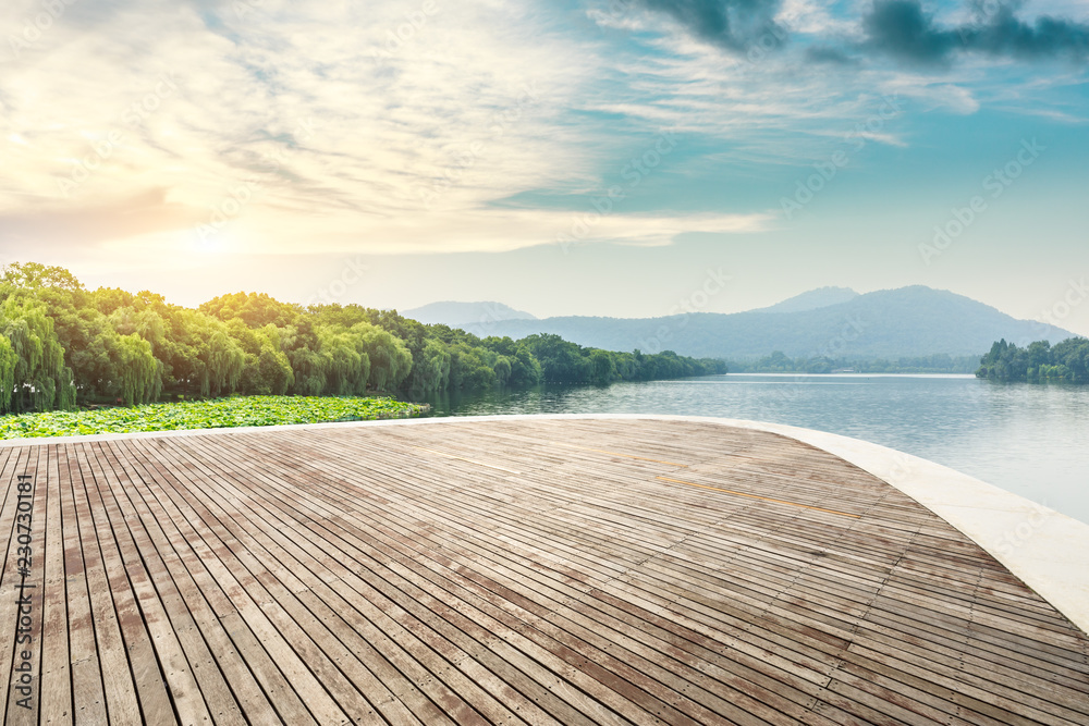 Empty wooden platform and beautiful mountain with lake