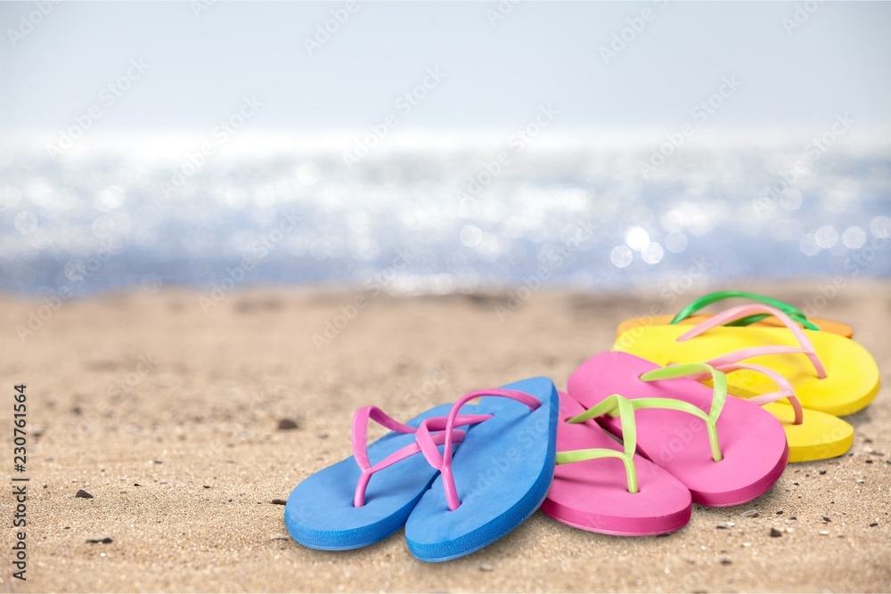 Pairs Of Flip-flops On Beach, vacation concept