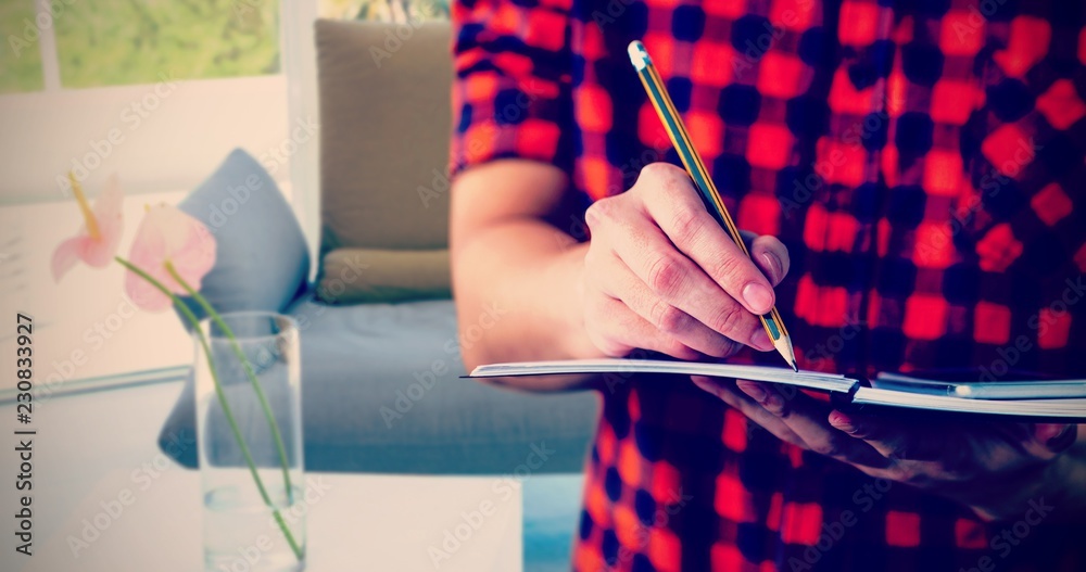 Composite image of hipster taking notes on notebooks