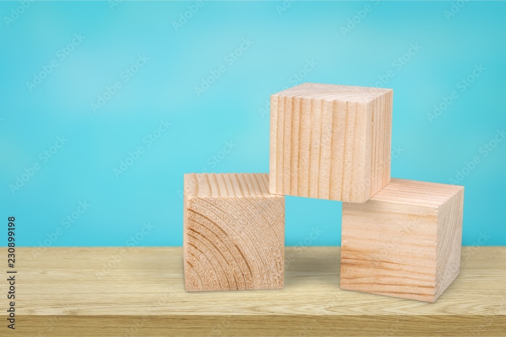 Wooden cubes on table background