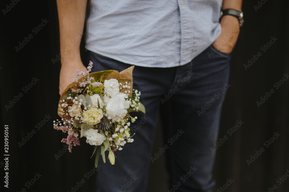 Man holding a bouquet of flowers