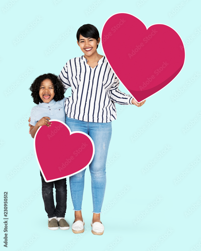 Happy mother and son holding heart icons