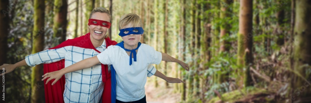 Composite image of mother and son pretending to be superhero