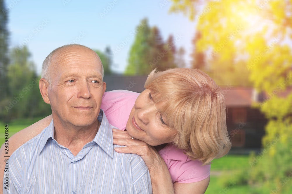 Portrait of happy senior couple smiling  in park