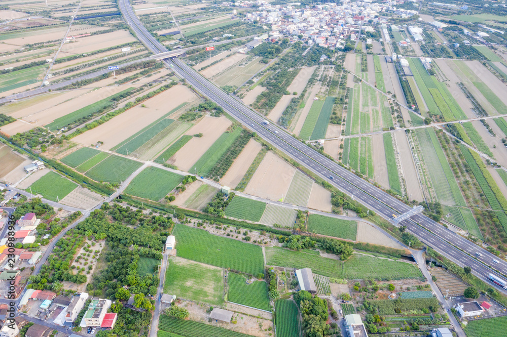 Fields with various types of agriculture and villages beside with air pollution in winter morning, T