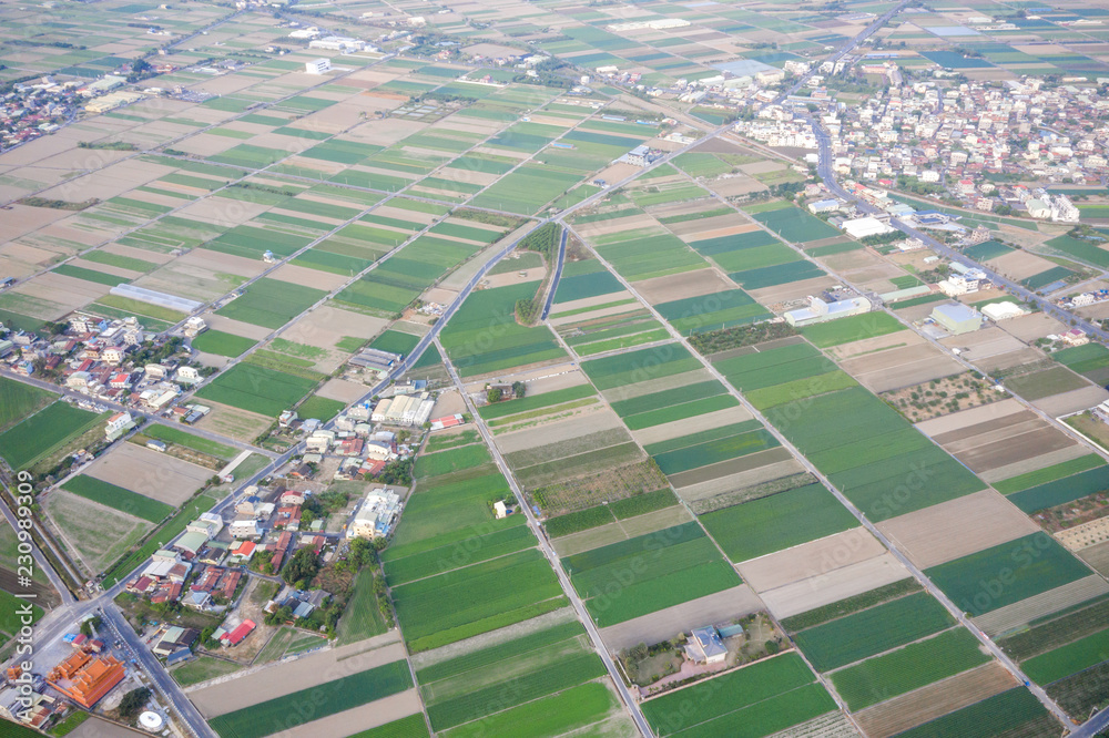 Fields with various types of agriculture and villages beside with air pollution in winter morning, T