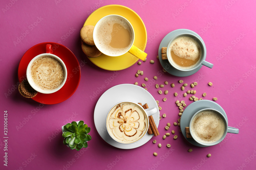 Many cups with tasty aromatic coffee on color background, flat lay