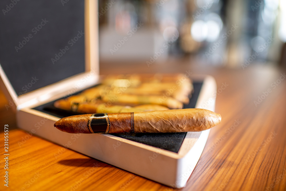 Close-up of luxury cigar set on the wooden table indoors