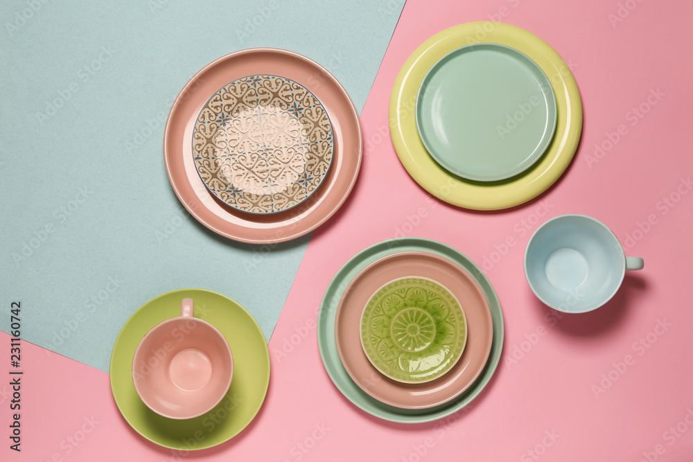 Set of clean tableware on color  background