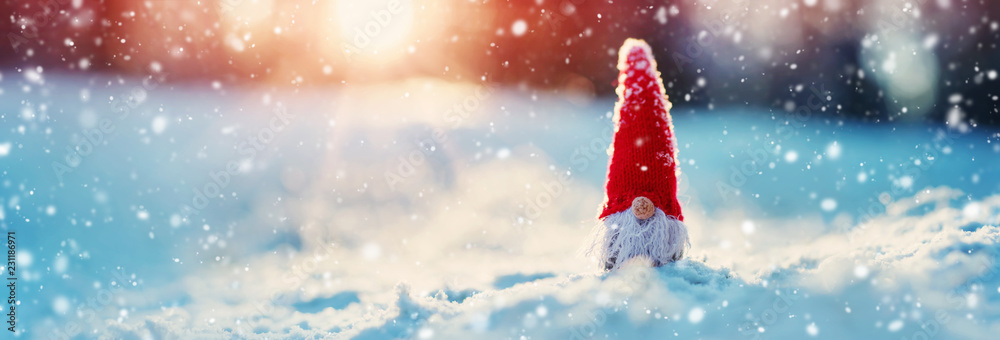 little knitted snowmans on soft snow on blue background