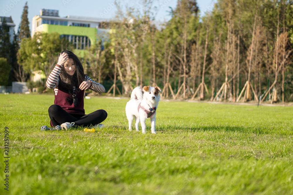 Dog and hostess, park background