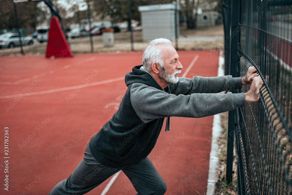 Senior man exercising outdoors.