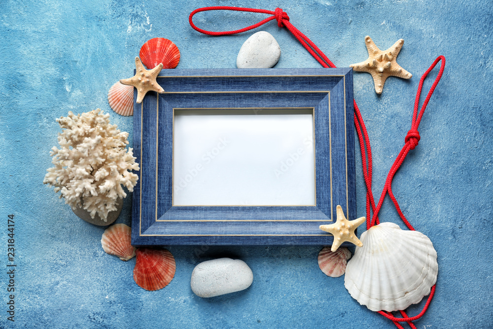 Empty frame with sea shells, starfishes and stones on color background