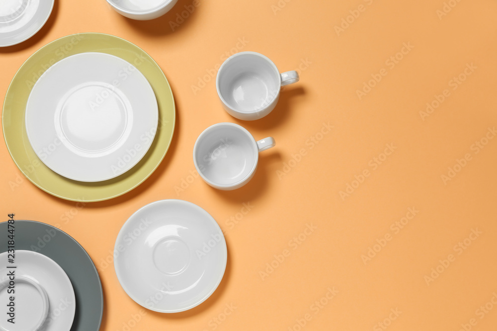 Set of clean tableware on color  background