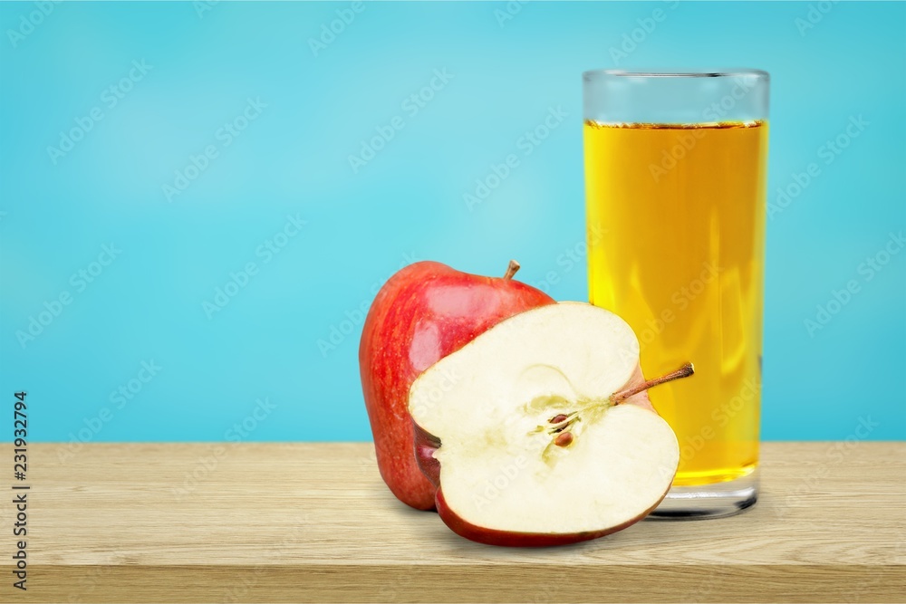 Glass of delicious apple juice on natural