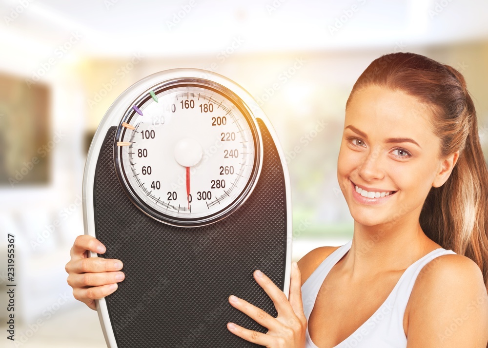 Young woman with scales isolated