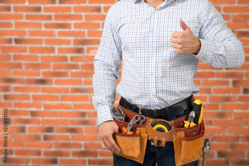 Worker with a tool belt. Isolated over white background.