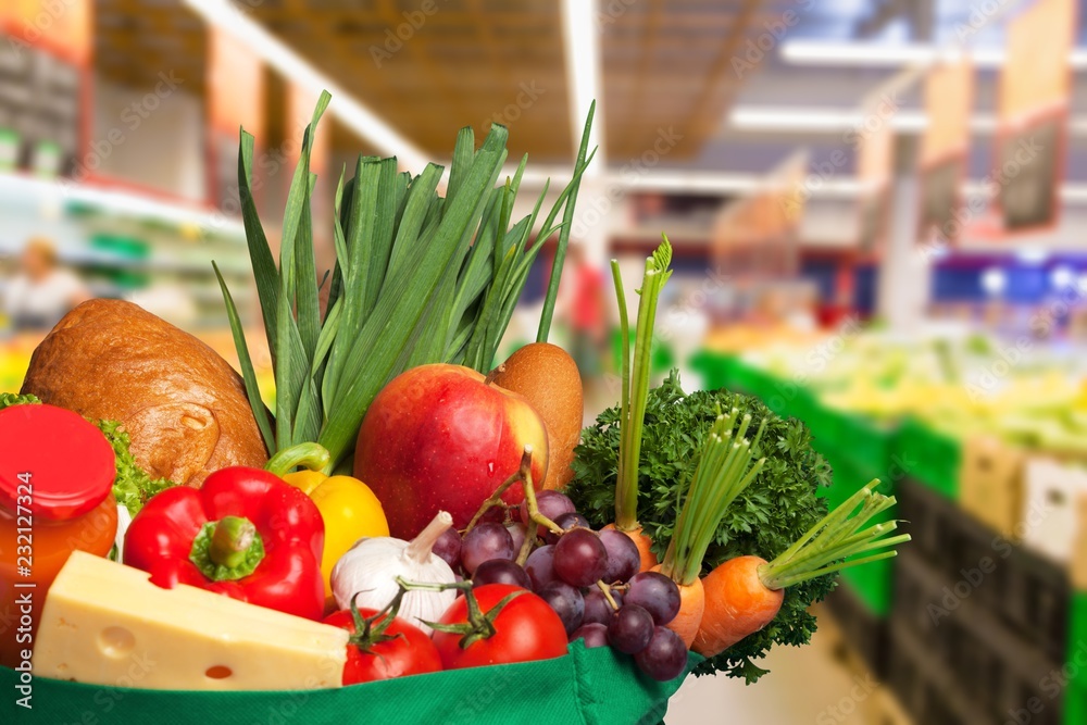 Shopping bag with variety of grocery products, close-up view