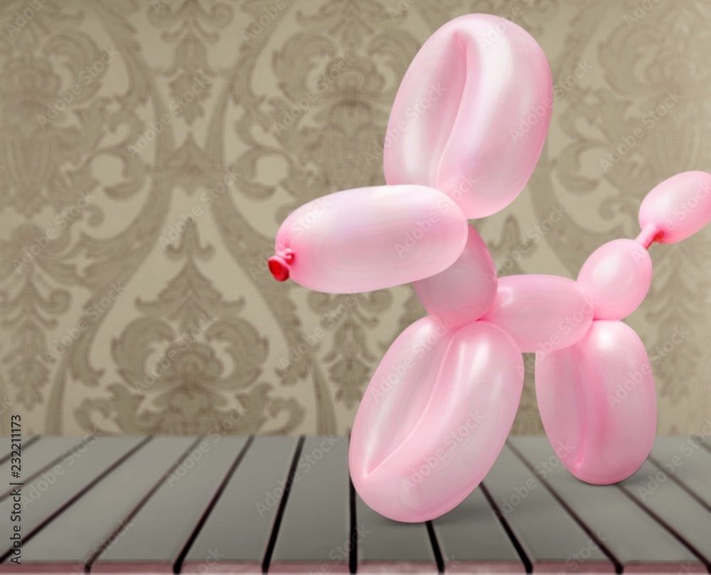 Pink balloon in form of dog on background