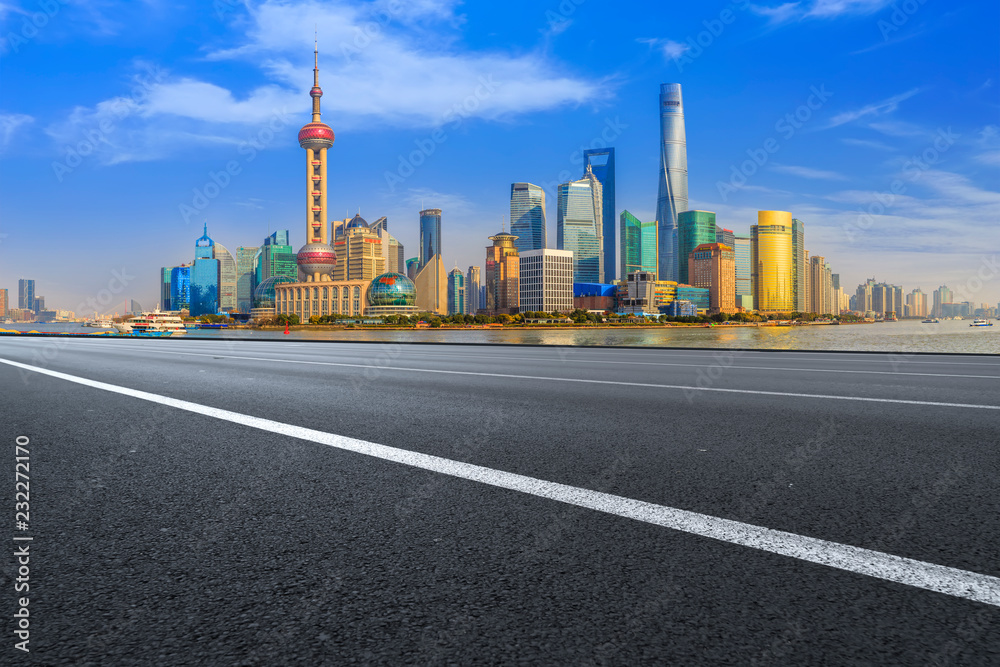 Empty asphalt road along modern commercial buildings in Chinas cities