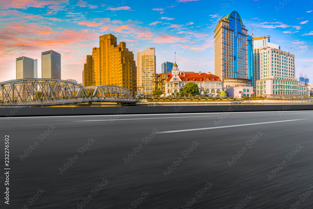 Empty asphalt road along modern commercial buildings in Chinas cities