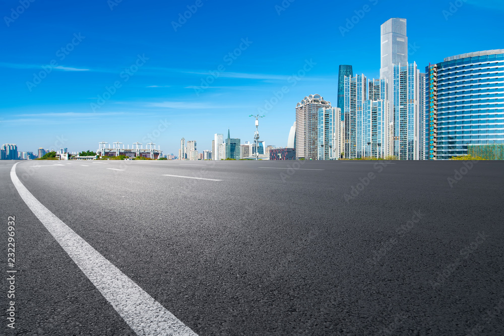 Empty asphalt road along modern commercial buildings in Chinas cities