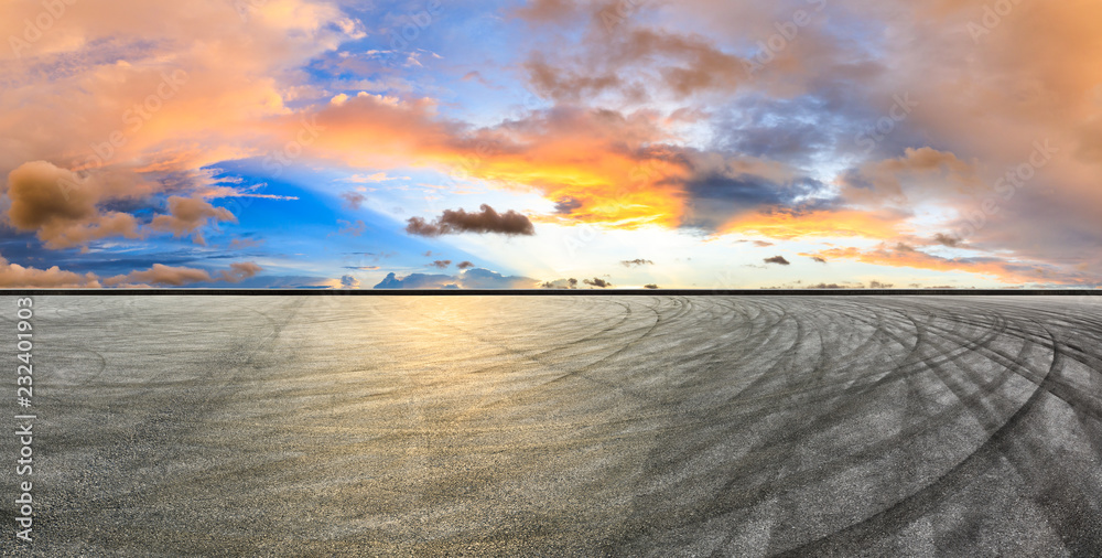 Asphalt road pavement and dramatic sky panorama at sunset