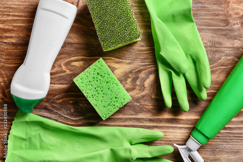 Cleaning supplies on wooden background