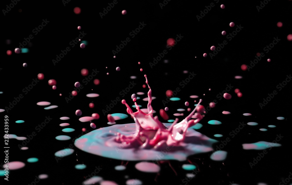 Splashes of color water on dark background