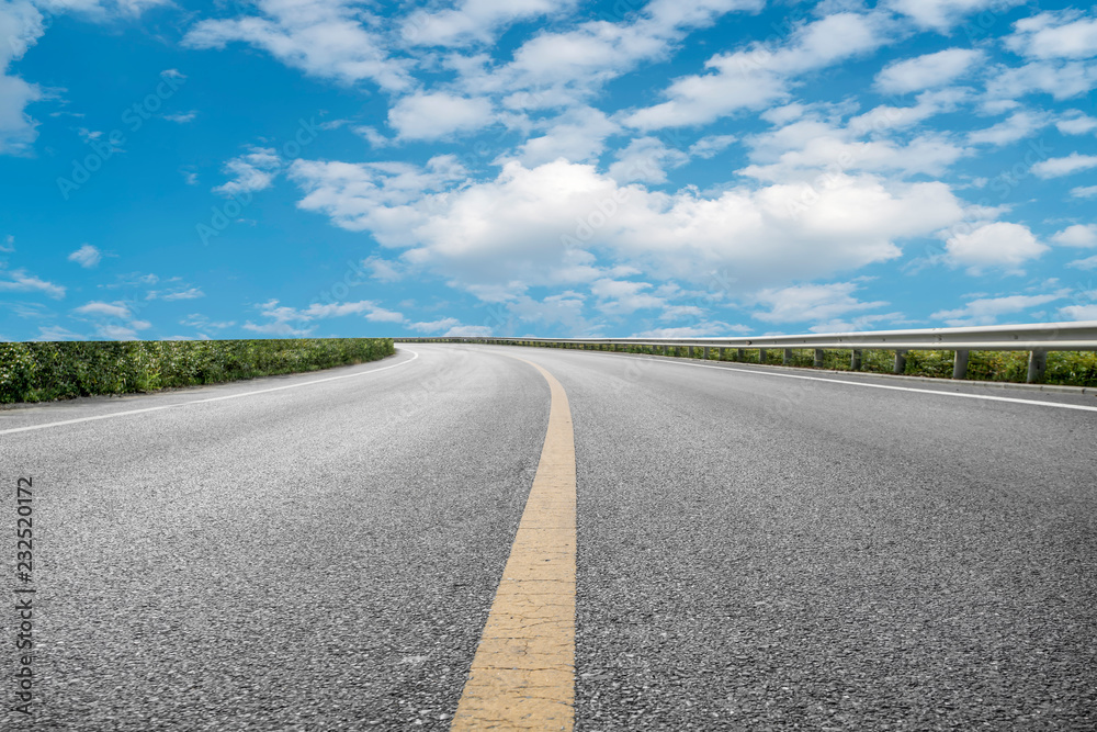 Empty highway asphalt pavement and sky cloud landscape..