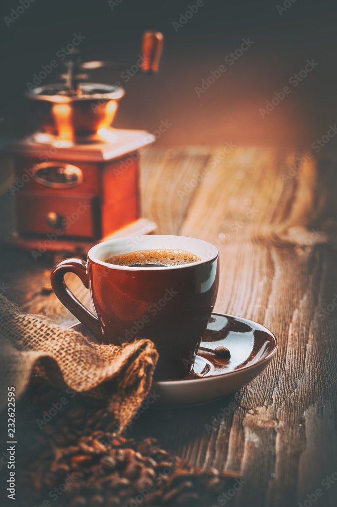 Coffee. Cup of espresso and coffee grinder, roasted aroma Coffee beans on wooden table. Vertical art