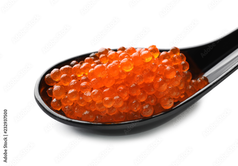 Spoon with delicious red caviar on white background, closeup