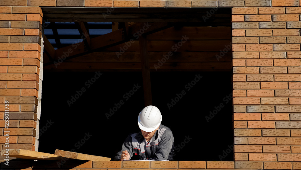 Man in window of building house