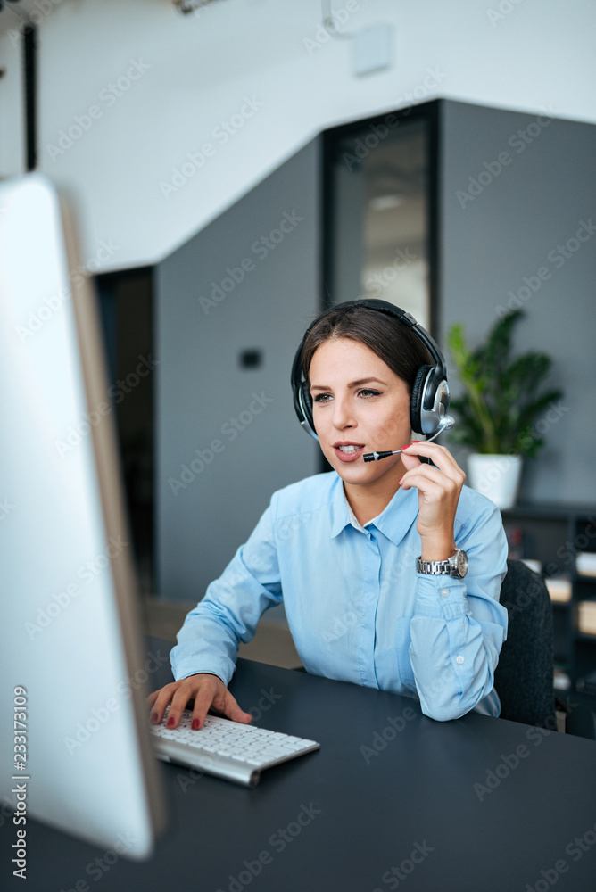 Beautiful female operator talking with a client.