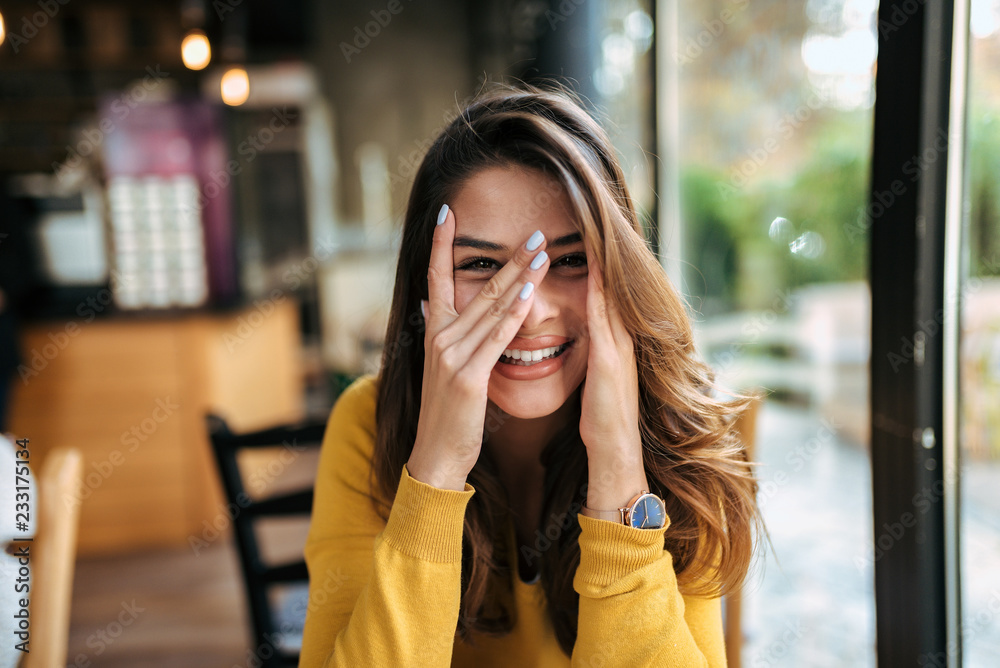 Portrait of a beautiful girl having fun in the cafe.