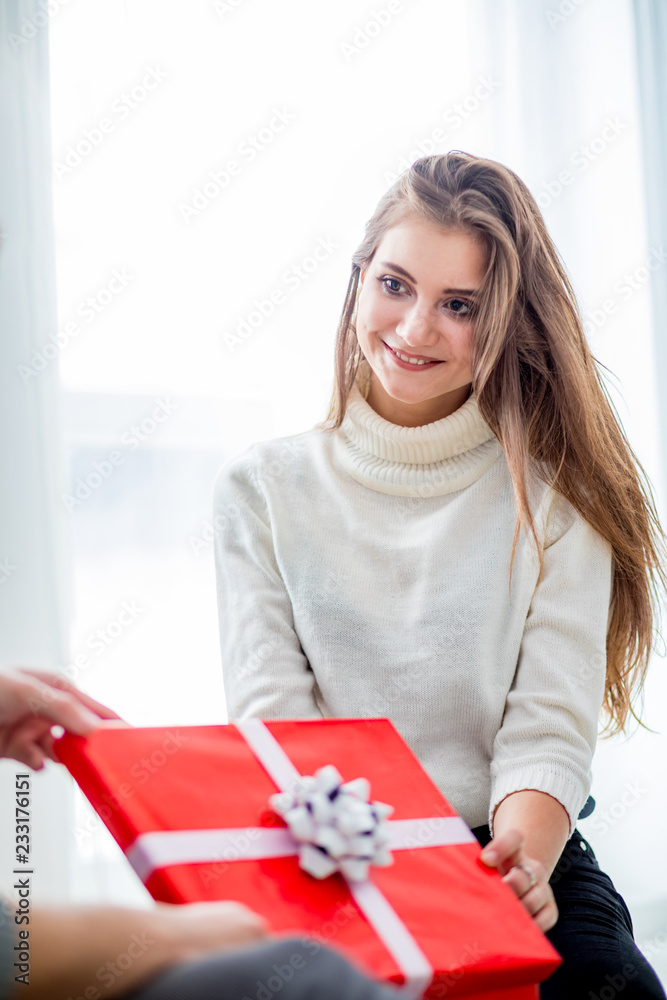 Cheerful woman with Christmas gift