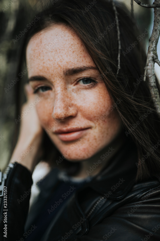 Portrait of a young woman with freckles