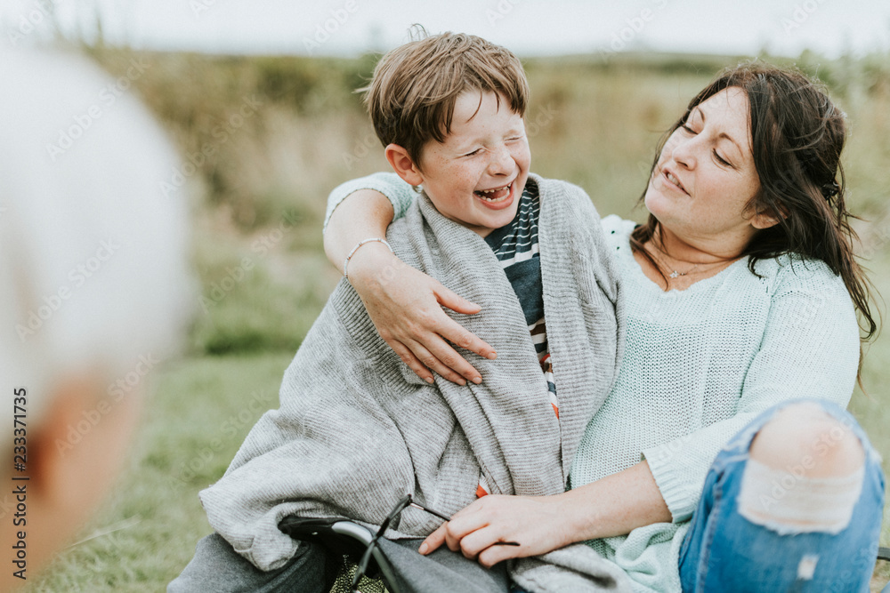 Mother embracing her cheerful son