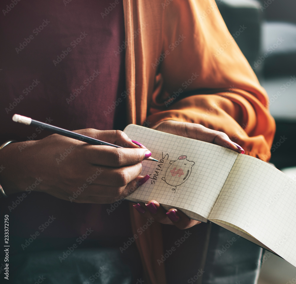 Woman writing down on an empty notepad