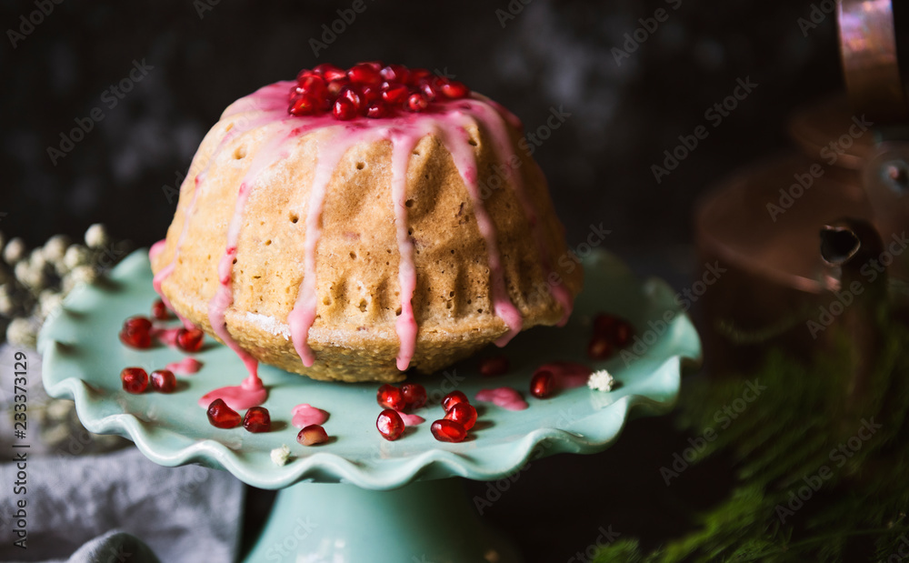 Dome shaped cake topped with pomegranate